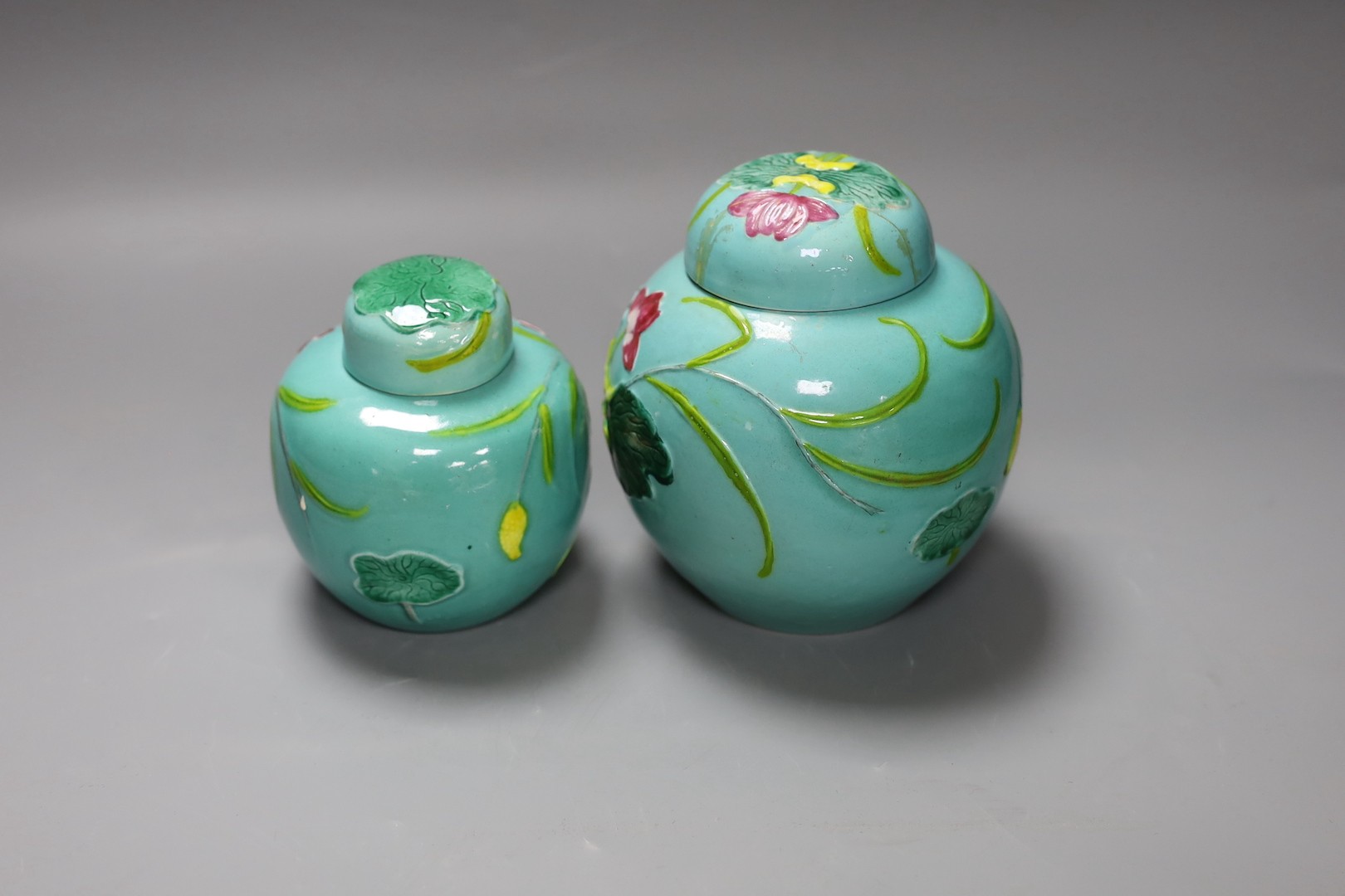 Two Chinese polychrome porcelain jars and covers, 20th century, tallest 15 cms high.